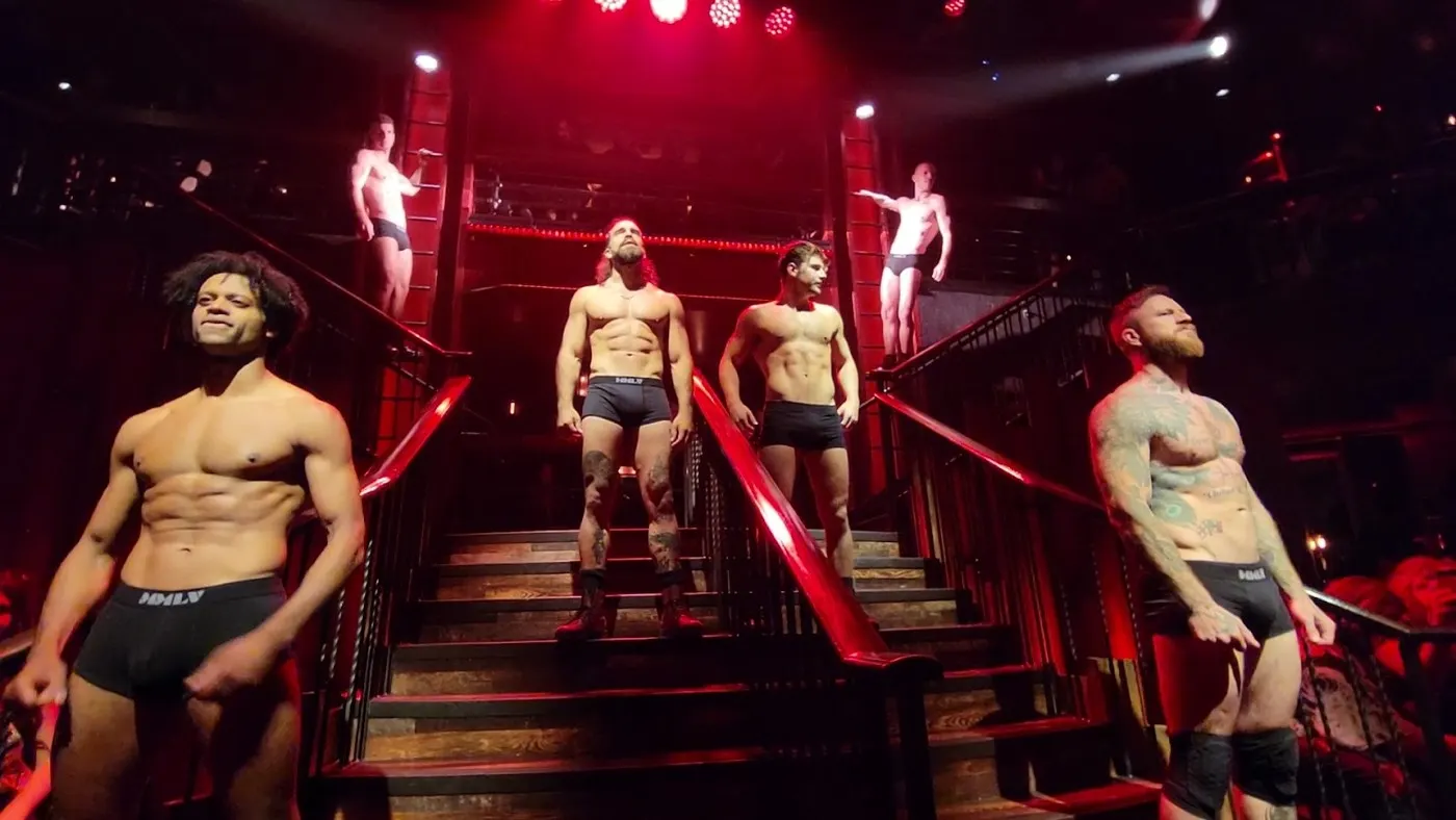 Magic Mike Live dancers on the red-lit stairs